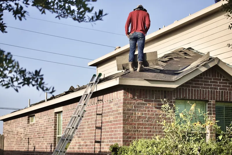 Professional roofer working on a residential roof in Oakwood Court